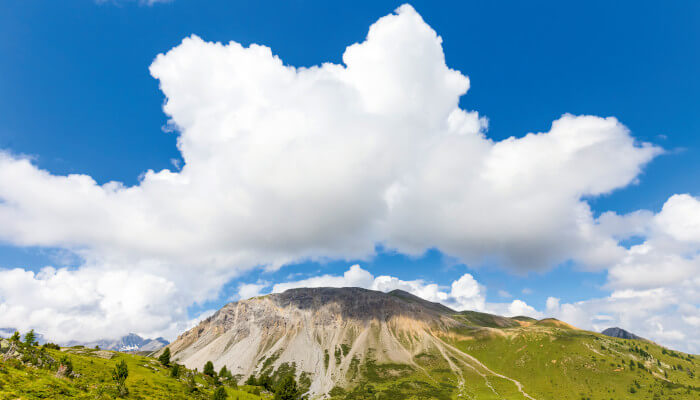 Berggipfel mit blauen Himmel und weissen Wolken