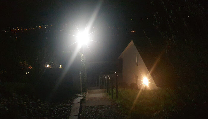 Einfamilienhaus in der Nacht mit beleuchtetem Gehweg