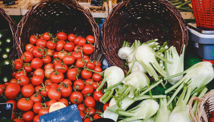 Rote Tomaten und weisser Kohl in geflochtenem Korb